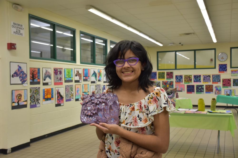 Middle school student and their artwork 