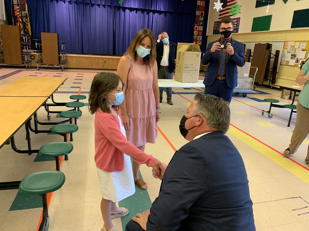 Albany County Executive Daniel McCoy shaking hands with AWB third grade student Kylie McGuiness.