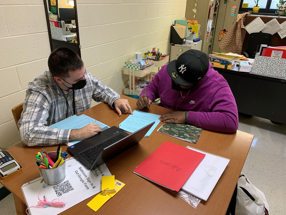 Teacher Helping Student