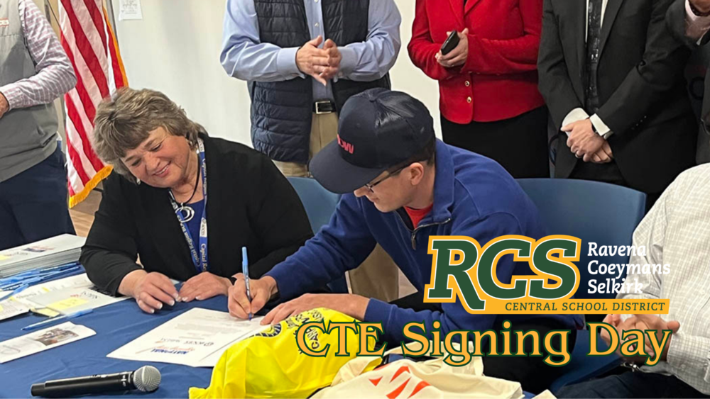 A student signs his letter of intent on CTE Signing Day